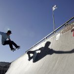 A skateboarder rides a ramp outside the World Cyber Games