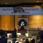 An image of activist Angela Davis is displayed above the entrance to the Seattle Police Department